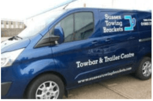 Professional Towbar Installation Worthing by Sussex Towing Brackets. Image shows a dark blue car fitted with a detachable towbar, ready for attaching a bike rack or trailer, symbolizing freedom for outdoor adventures.